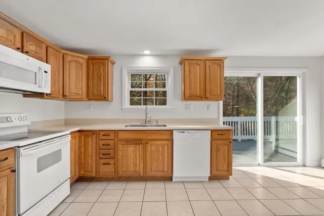 a large kitchen with a stove a sink dishwasher and a refrigerator