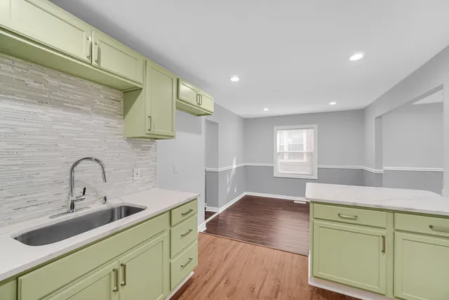 a kitchen with a sink and wooden cabinets