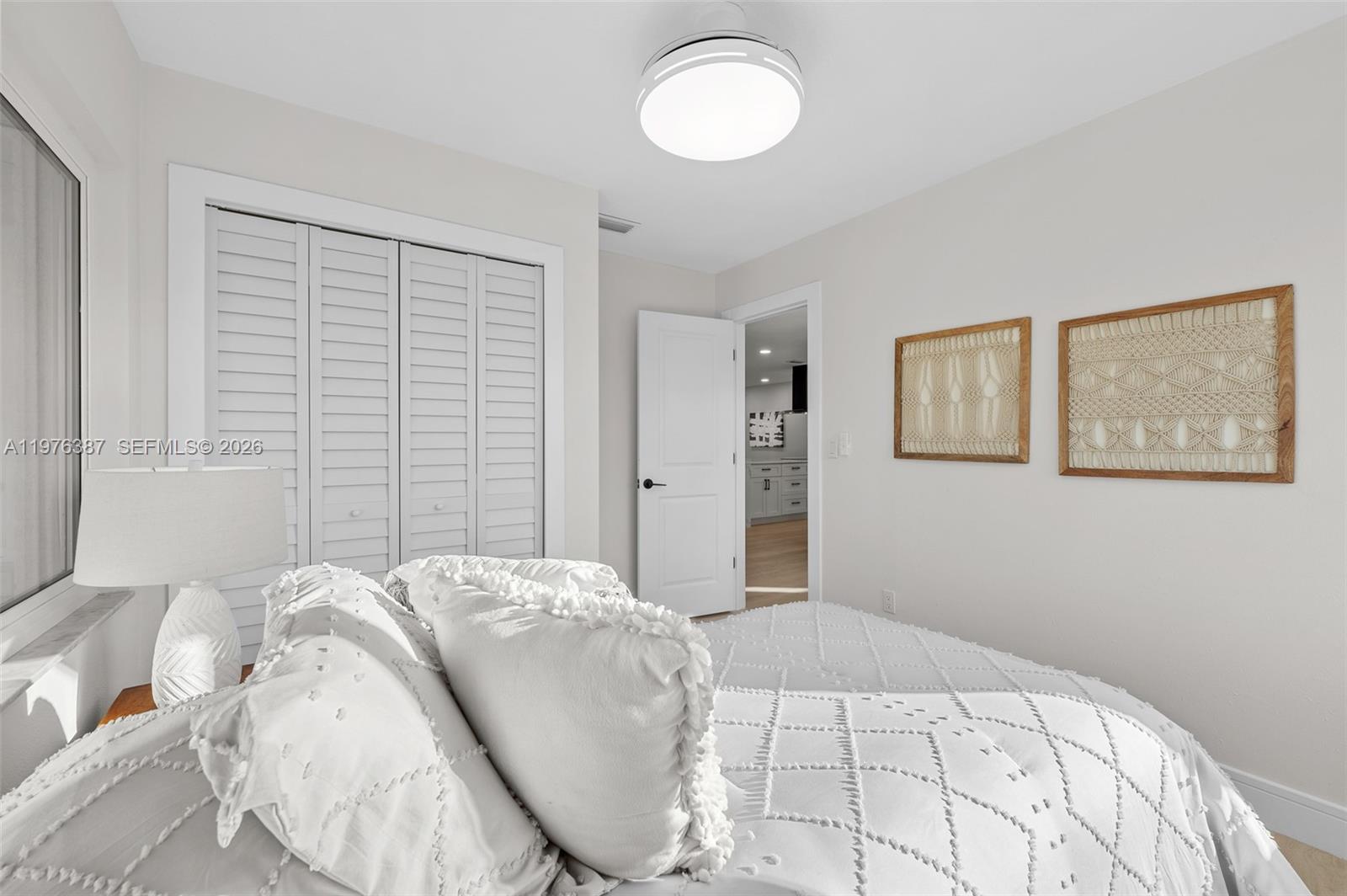 105 12th Street Southwest Ruskin, FL 33570 - Photo 11 of 89 a bedroom with a large bed and a window