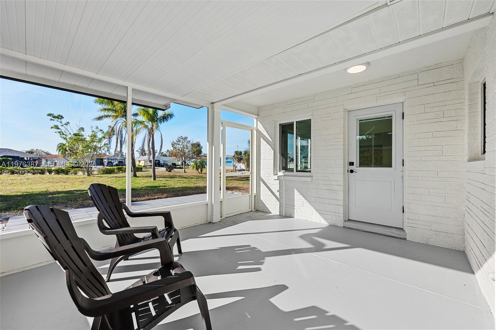 105 12th Street Southwest Ruskin, FL 33570 - Photo 17 of 89 a view of a patio with a table chairs and garden view