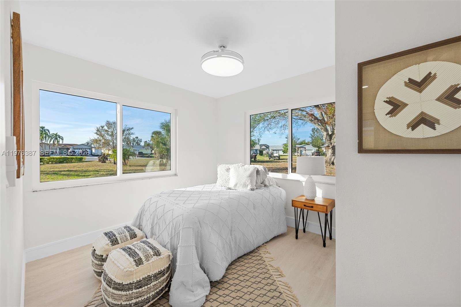 105 12th Street Southwest Ruskin, FL 33570 - Photo 28 of 89 a bed room with a bed and a chair