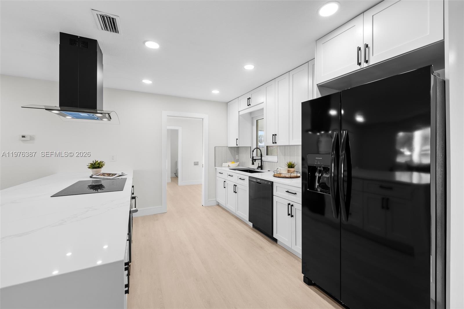 105 12th Street Southwest Ruskin, FL 33570 - Photo 33 of 89 a kitchen with a sink stainless steel appliances and cabinets