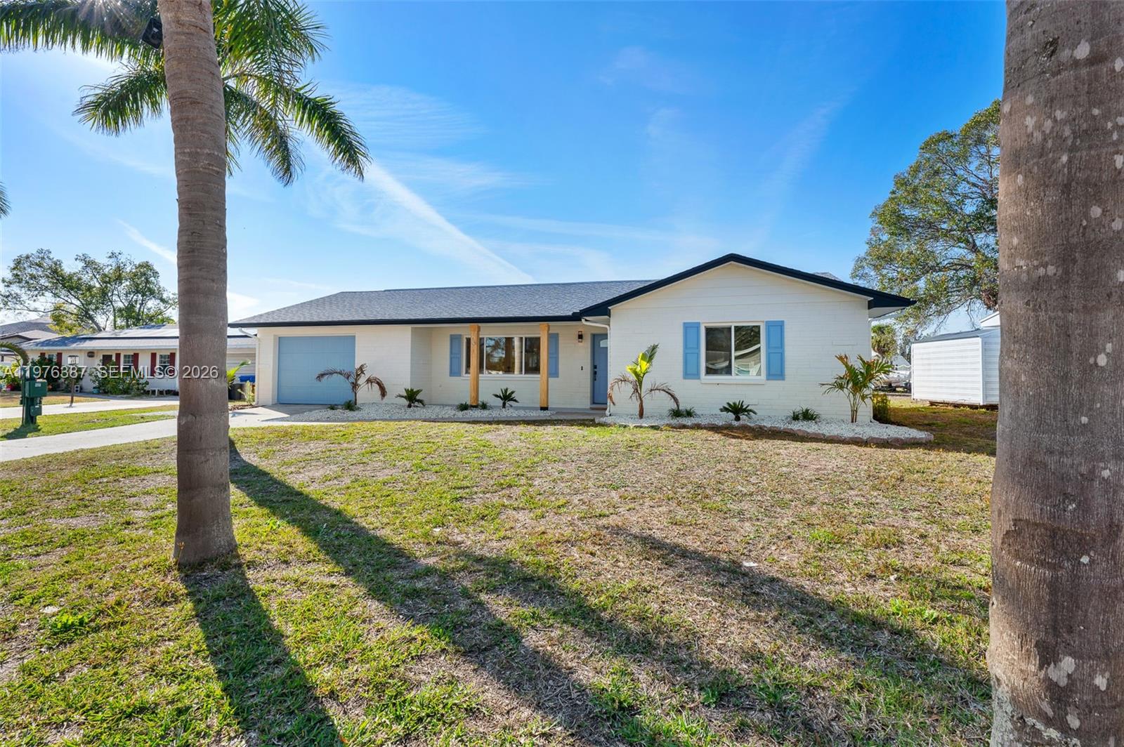 105 12th Street Southwest Ruskin, FL 33570 - Photo 56 of 89 a front view of house with yard and swimming pool