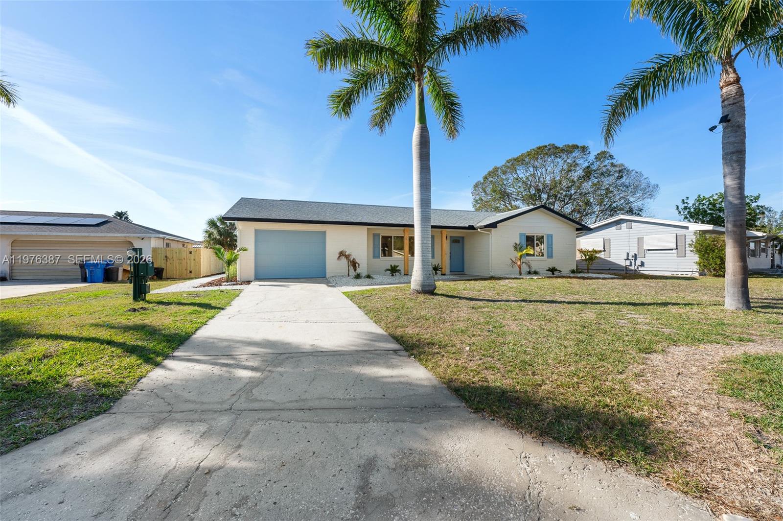 105 12th Street Southwest Ruskin, FL 33570 - Photo 59 of 89 a front view of a house with a garden and yard