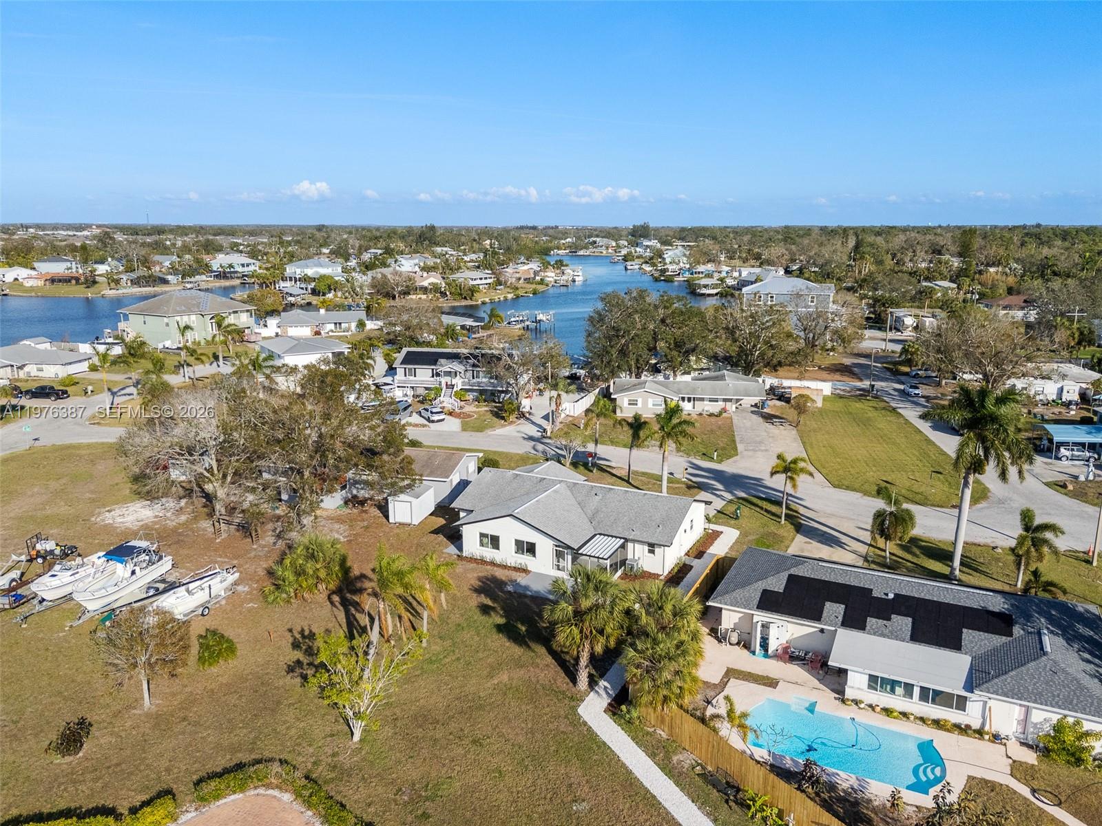 105 12th Street Southwest Ruskin, FL 33570 - Photo 77 of 89 an aerial view of a city with lots of residential buildings ocean and mountain view in back