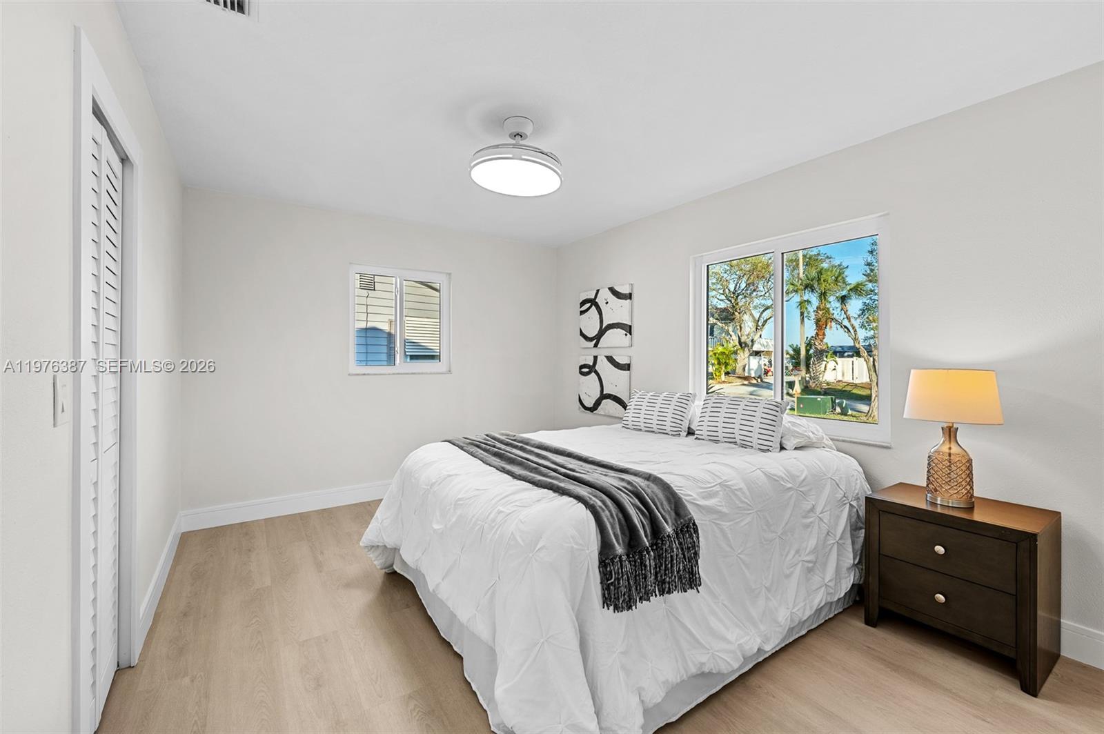 105 12th Street Southwest Ruskin, FL 33570 - Photo 8 of 89 a bedroom with a bed and a lamp
