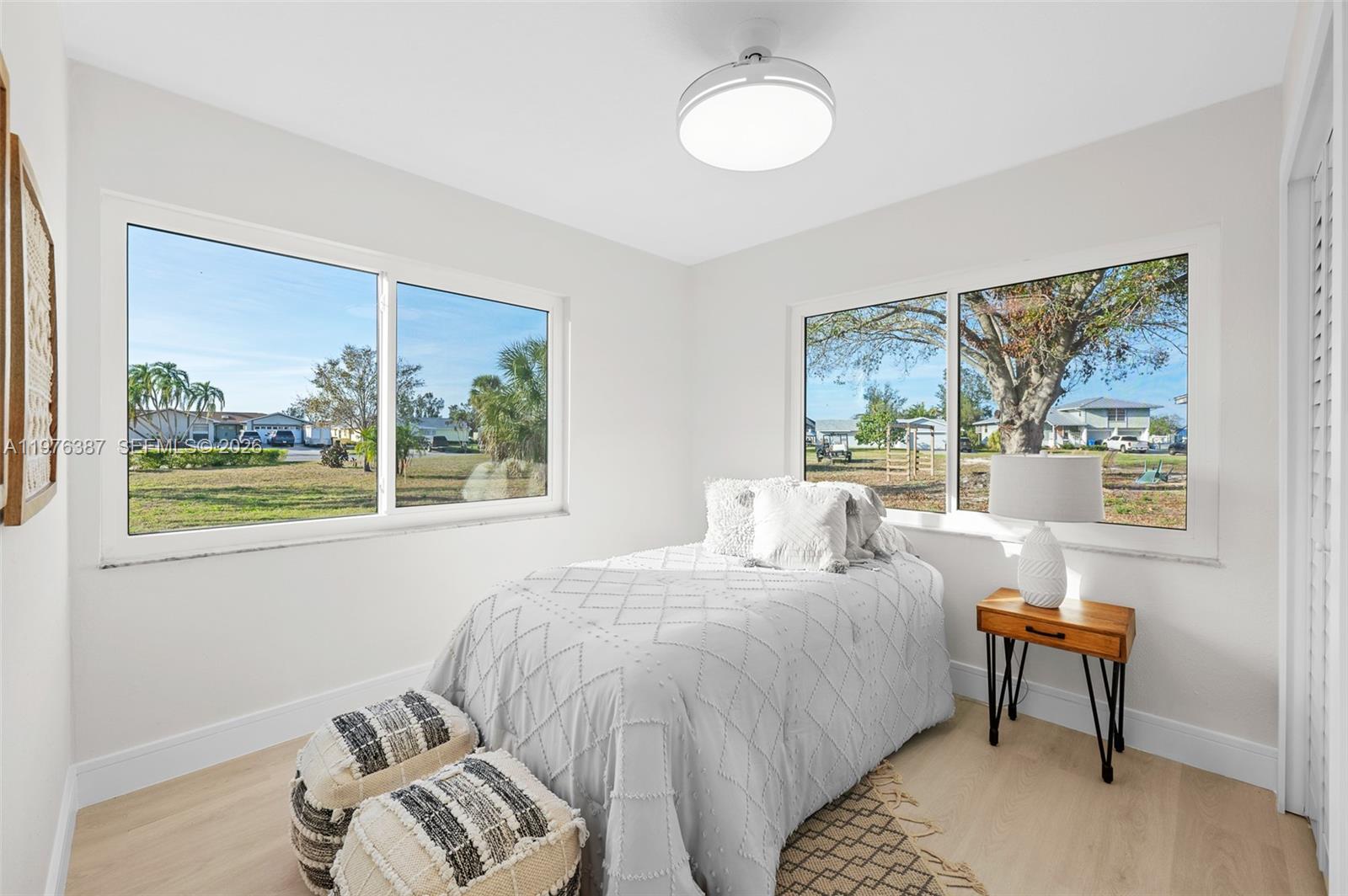 105 12th Street Southwest Ruskin, FL 33570 - Photo 10 of 89 a bedroom with a bed and a painting on the wall