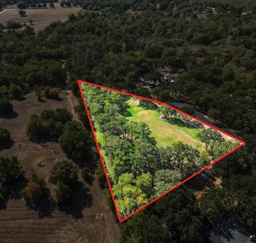 a view of a small yard with wooden fence
