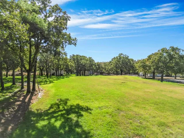 a view of a yard with a lake view
