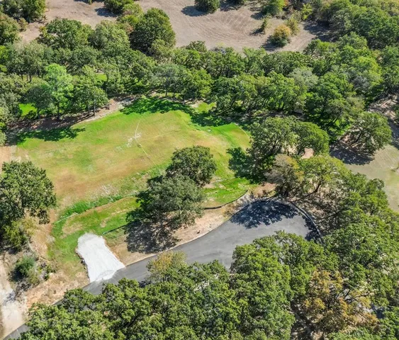 an aerial view of a houses with a yard