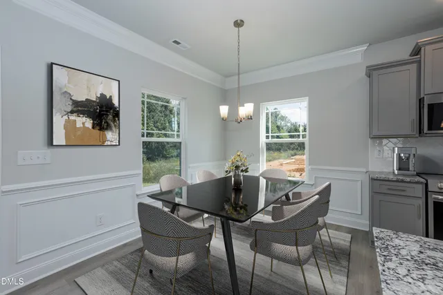 a dining room with furniture and window