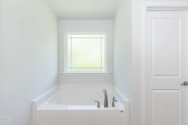a white bath tub sitting next to a window