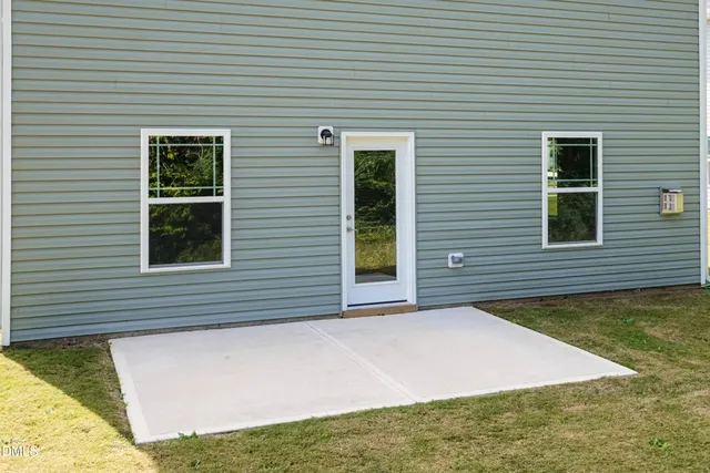 a view of a house with pool and a yard