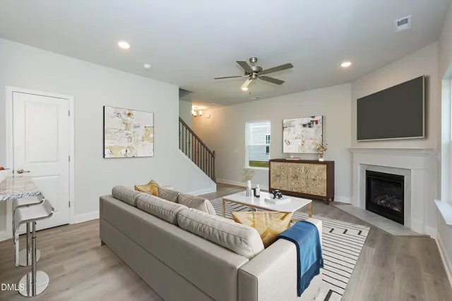 a living room with furniture a fireplace and a flat screen tv