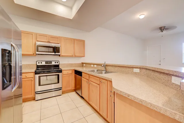 a kitchen with a sink stove and microwave