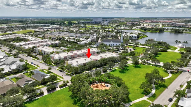 an aerial view of residential houses with outdoor space and trees