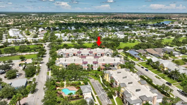 an aerial view of residential houses with outdoor space and swimming pool
