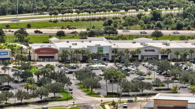 an aerial view of a residential houses with outdoor space and lake view