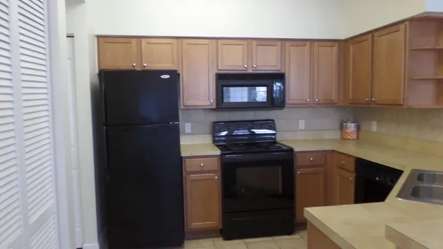 a kitchen with a sink and a refrigerator
