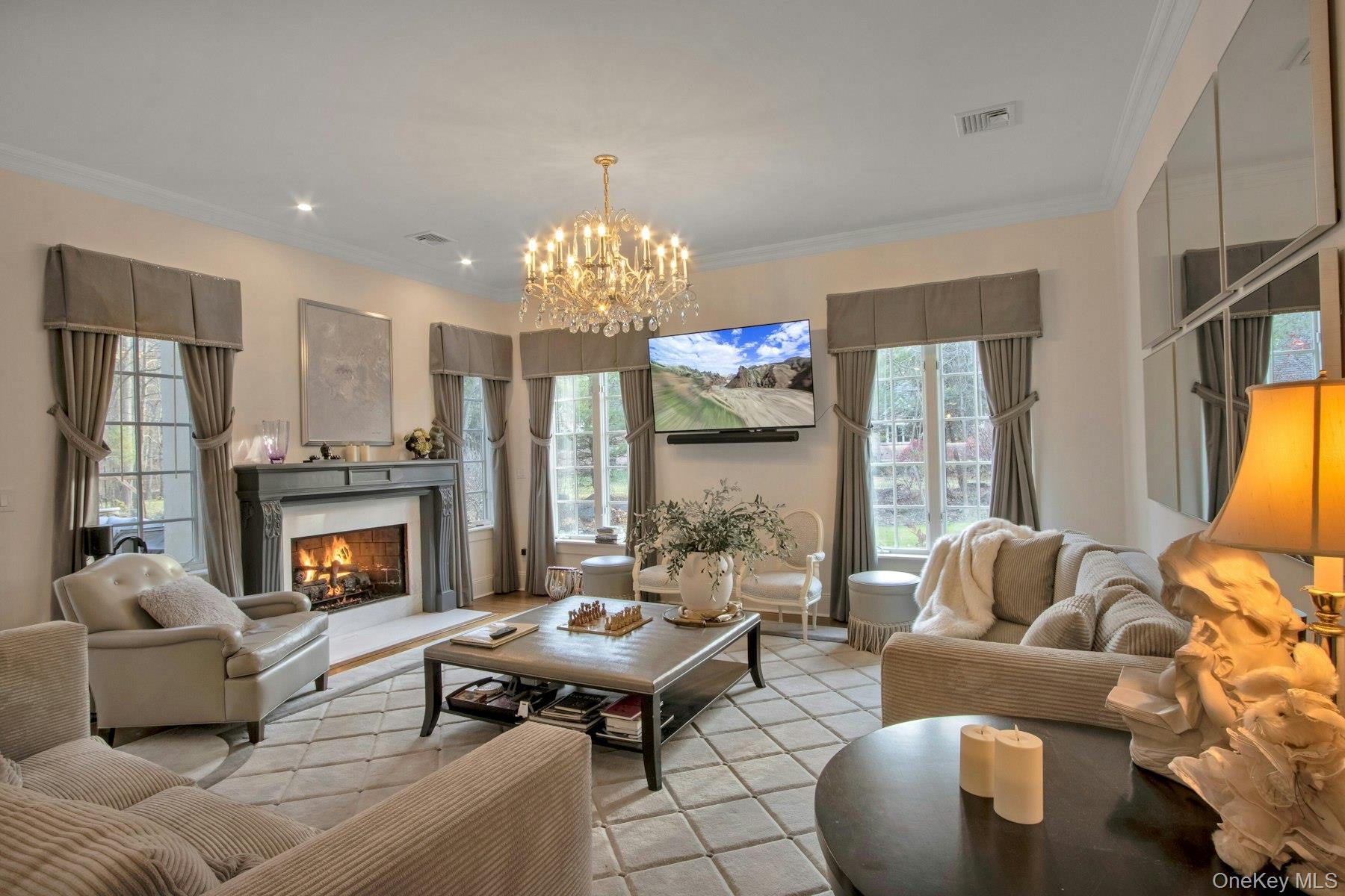 129 Washington Spring Road Palisades, NY 10964 - Photo 5 of 44 Family room with crown molding and an inviting chandelier