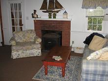 72 Beaten Road Dennis Port, MA 02639 - Photo 2 of 8 a living room with furniture and a fireplace