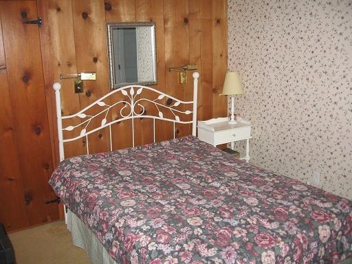 72 Beaten Road Dennis Port, MA 02639 - Photo 5 of 8 a bedroom with a bed and a wall painting