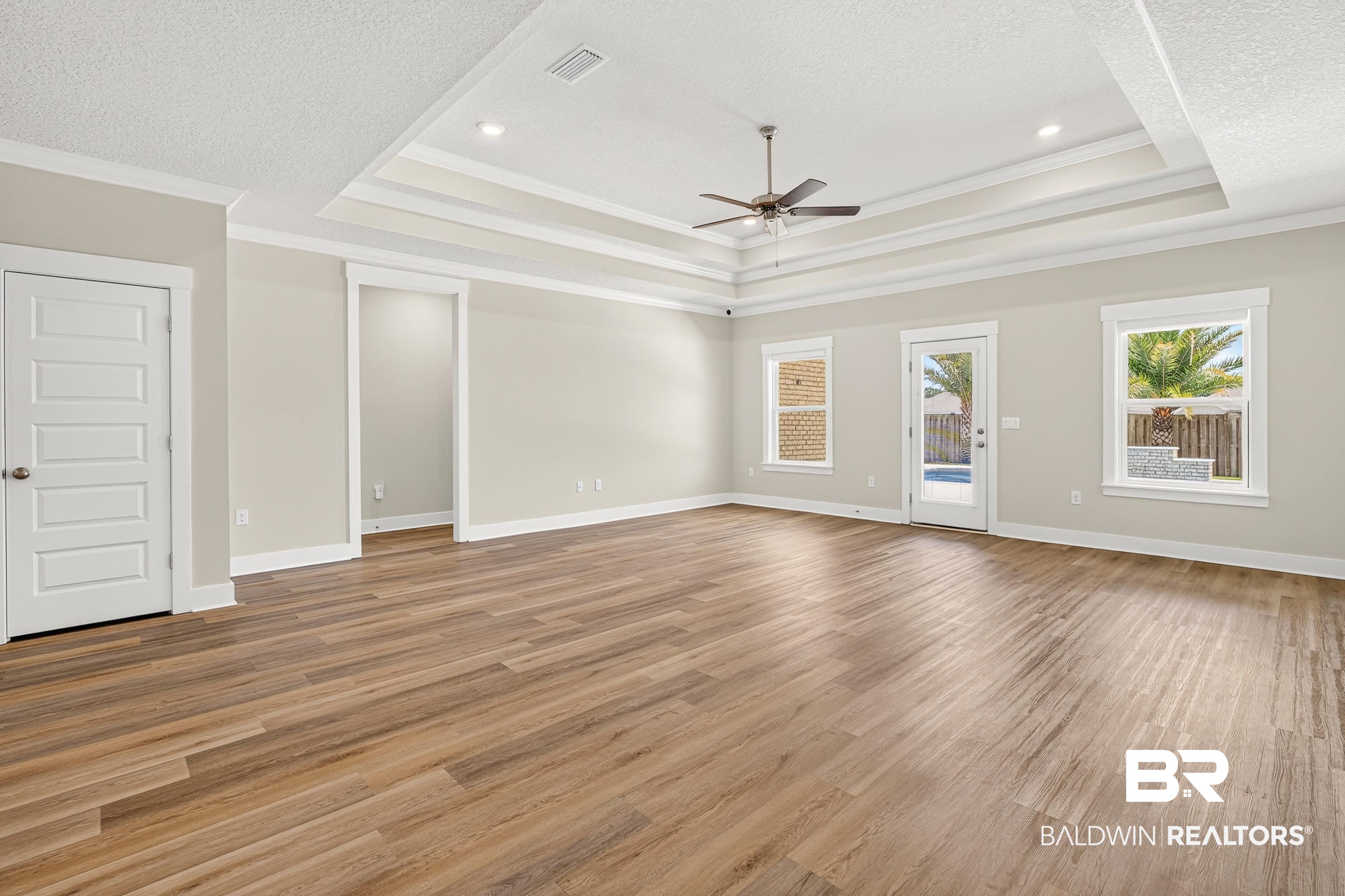 1724 Partridge Street Foley, AL 36535 - Photo 23 of 62 Spacious room featuring wood-finish flooring, a tray ceiling with a ceiling fan, and recessed lighting