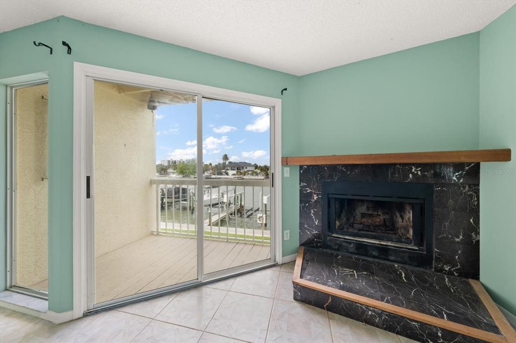 124 Marcdale Boulevard Indian Rocks Beach, FL 33785 - Photo 11 of 55 a living room with furniture and a fireplace