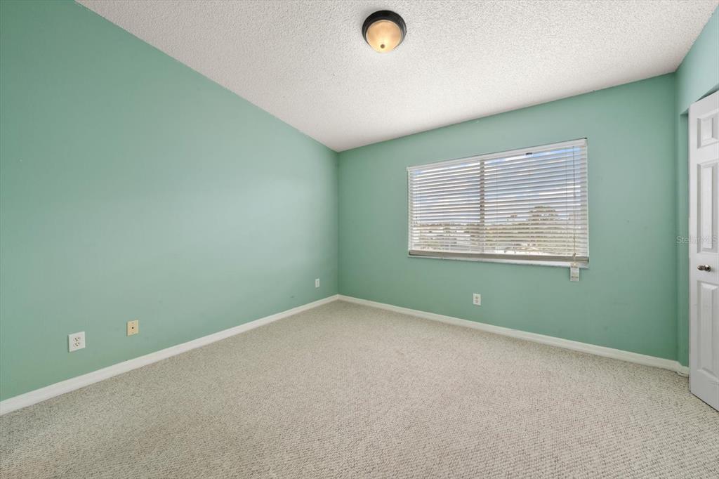 124 Marcdale Boulevard Indian Rocks Beach, FL 33785 - Photo 12 of 55 an empty room with a window and painted walls
