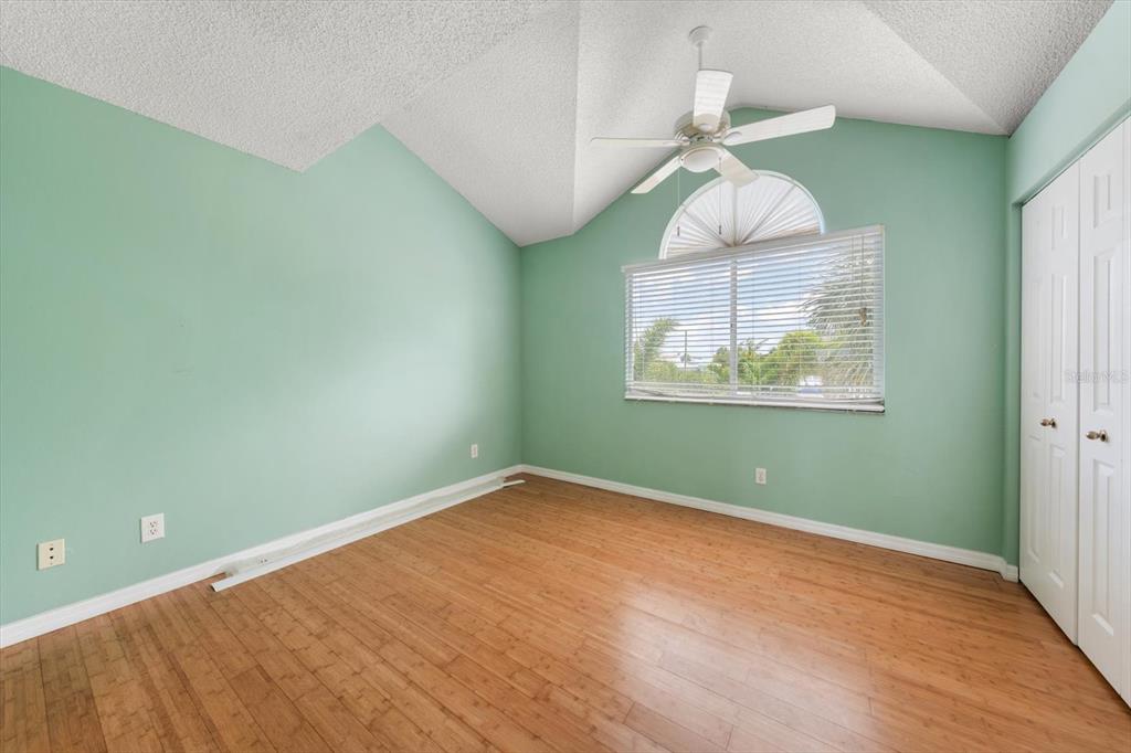 124 Marcdale Boulevard Indian Rocks Beach, FL 33785 - Photo 13 of 55 an empty room with wooden floor fan and windows