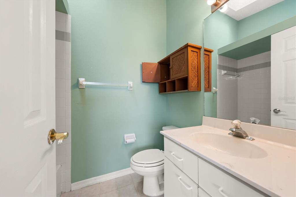 124 Marcdale Boulevard Indian Rocks Beach, FL 33785 - Photo 14 of 55 a bathroom with a sink mirror vanity and toilet