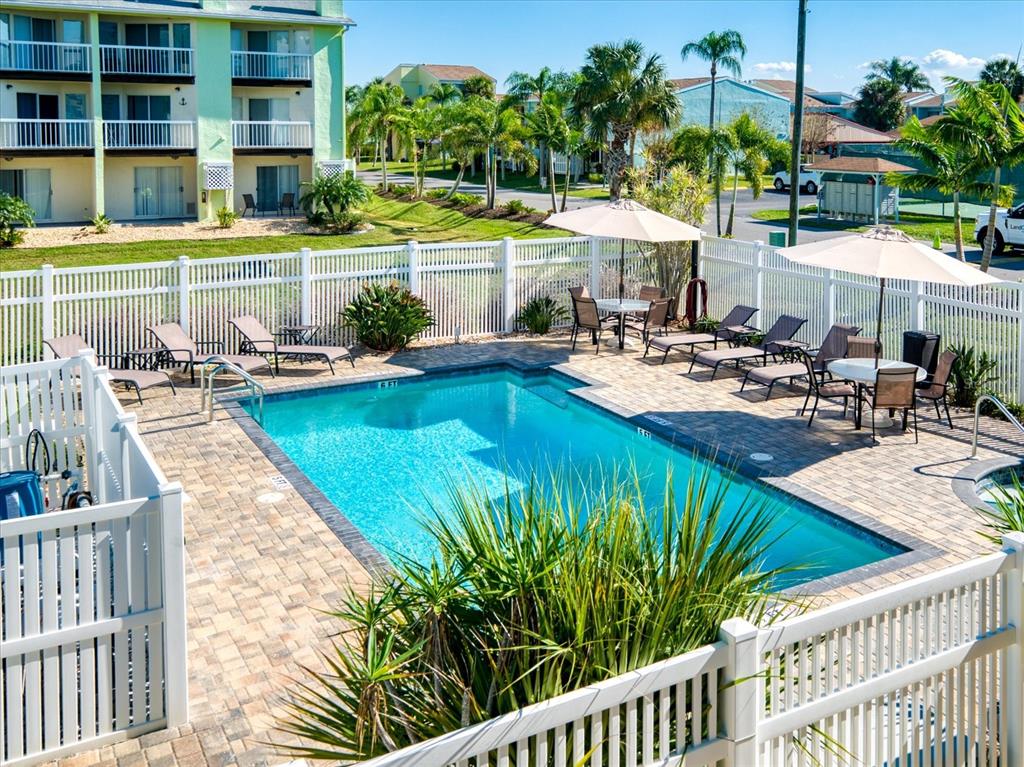 124 Marcdale Boulevard Indian Rocks Beach, FL 33785 - Photo 16 of 55 a view of a swimming pool with a lounge chairs