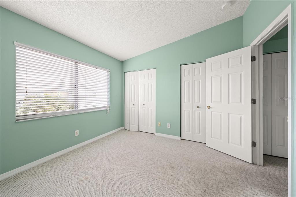 124 Marcdale Boulevard Indian Rocks Beach, FL 33785 - Photo 21 of 55 a view of an empty room with a window and a kitchen