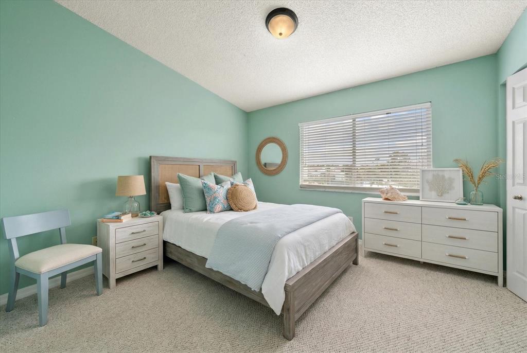 124 Marcdale Boulevard Indian Rocks Beach, FL 33785 - Photo 36 of 55 a bed room with a bed and a table