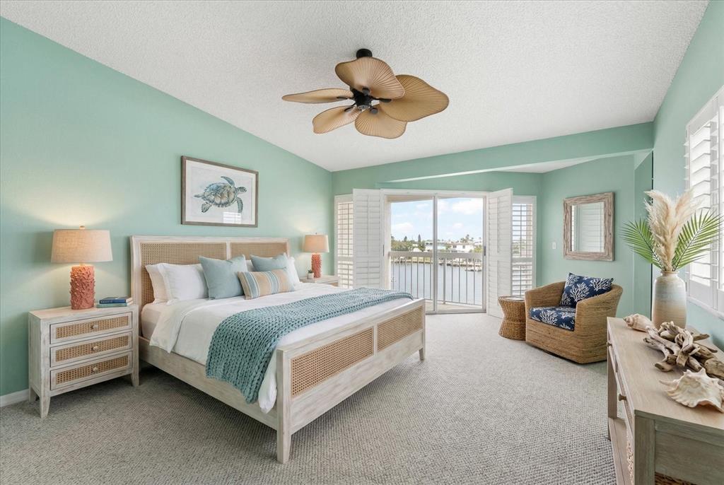 124 Marcdale Boulevard Indian Rocks Beach, FL 33785 - Photo 37 of 55 a spacious bedroom with a bed and glass window