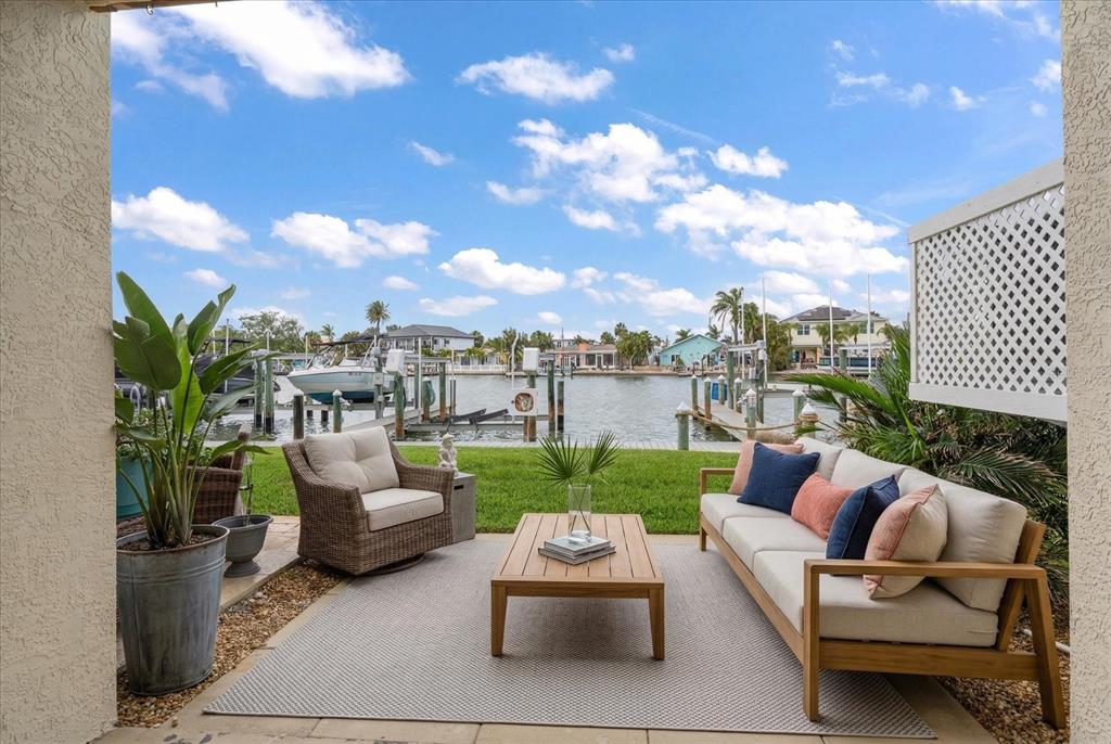 124 Marcdale Boulevard Indian Rocks Beach, FL 33785 - Photo 38 of 55 a patio with patio a couch and chairs