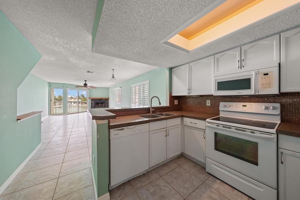124 Marcdale Boulevard Indian Rocks Beach, FL 33785 - Photo 40 of 55 a kitchen with a stove sink and cabinets
