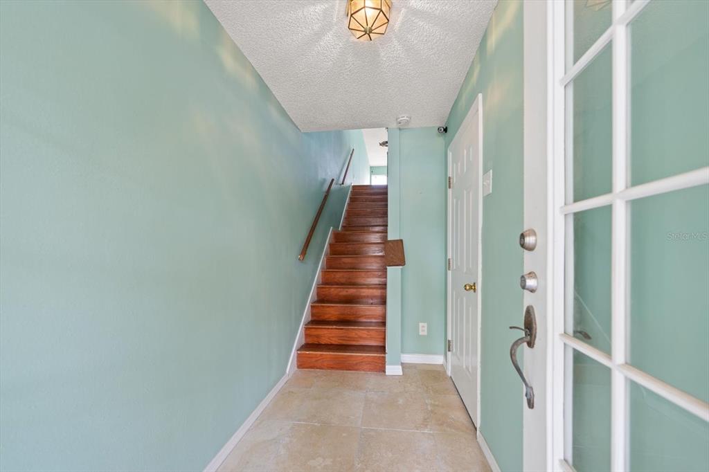 124 Marcdale Boulevard Indian Rocks Beach, FL 33785 - Photo 4 of 55 a view of a hallway with wooden staircase