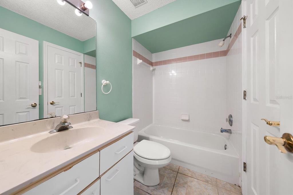 124 Marcdale Boulevard Indian Rocks Beach, FL 33785 - Photo 41 of 55 a bathroom with a sink a toilet and a bathtub