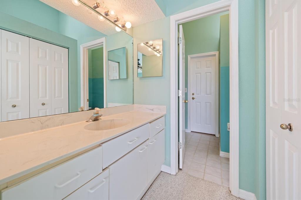 124 Marcdale Boulevard Indian Rocks Beach, FL 33785 - Photo 47 of 55 a bathroom with a sink and a mirror