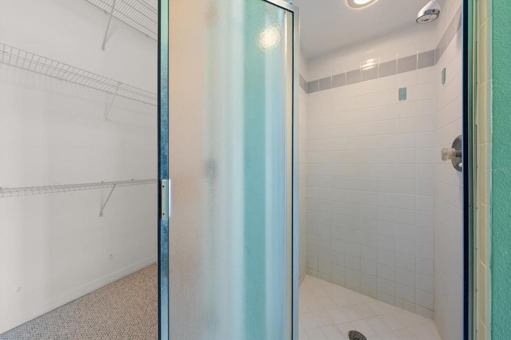 124 Marcdale Boulevard Indian Rocks Beach, FL 33785 - Photo 48 of 55 a bathroom with a glass shower door