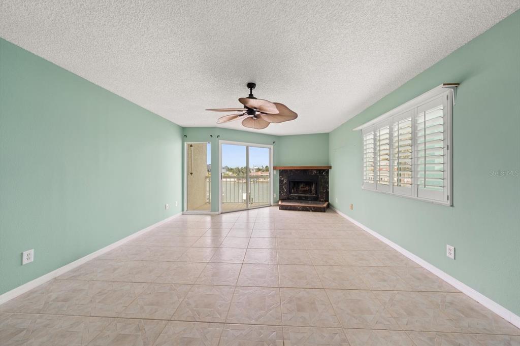 124 Marcdale Boulevard Indian Rocks Beach, FL 33785 - Photo 5 of 55 a view of a livingroom with a ceiling fan and window