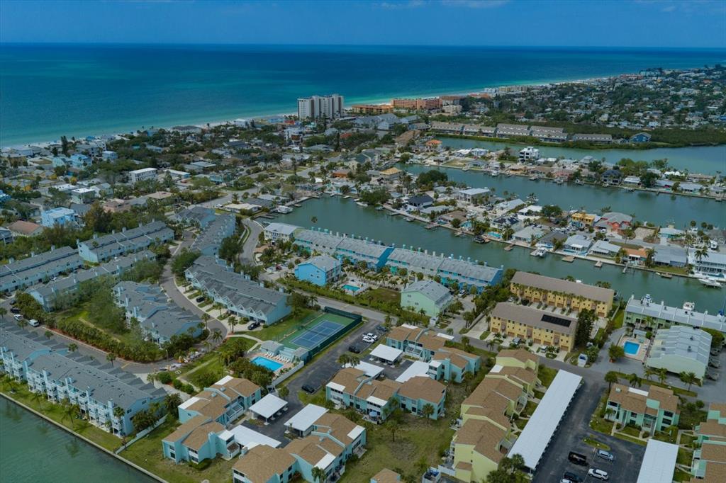 124 Marcdale Boulevard Indian Rocks Beach, FL 33785 - Photo 54 of 55 an aerial view of a city with lots of residential buildings ocean and mountain view in back