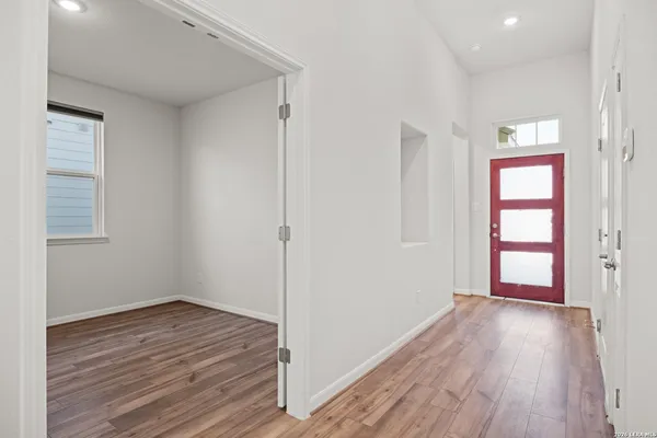 wooden floor in an empty room with a window