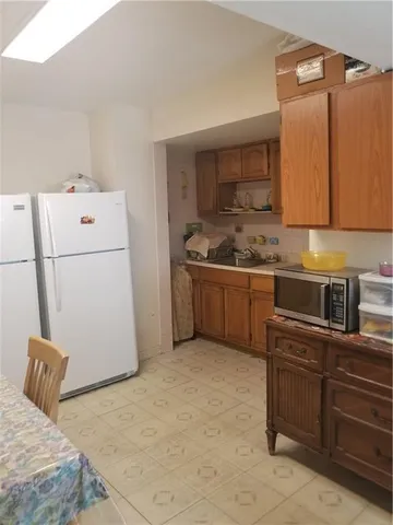 a kitchen with a refrigerator sink stove and cabinets