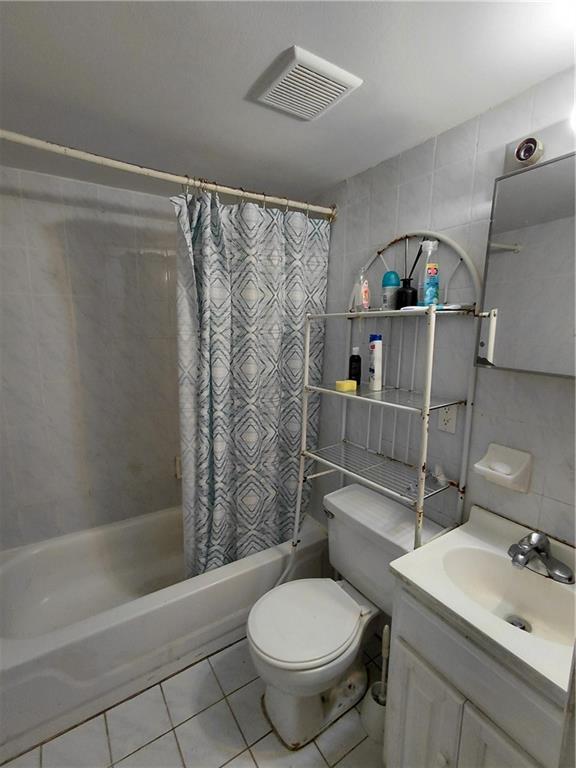 72 Brighton 1st Lane Brooklyn, NY 11235 - Photo 6 of 10 a bathroom with a sink toilet and shower