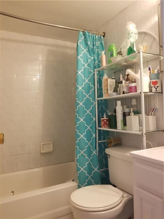 72 Brighton 1st Lane Brooklyn, NY 11235 - Photo 9 of 10 a bathroom with a toilet and shower