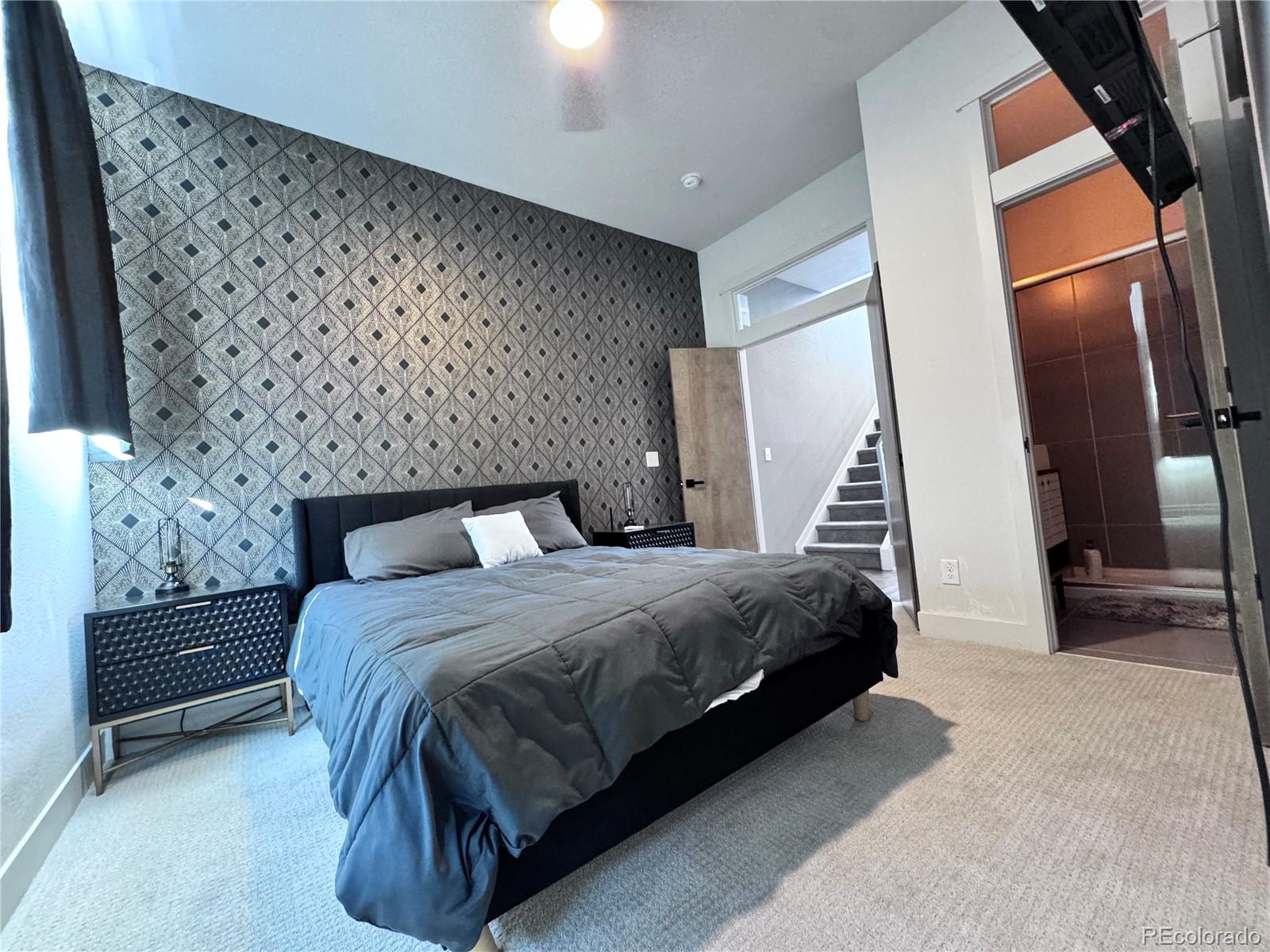 931 33rd Street Denver, CO 80205 - Photo 11 of 16 a bedroom with a large bed and a couch