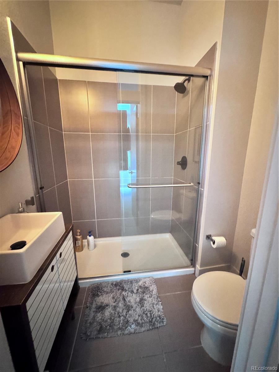 931 33rd Street Denver, CO 80205 - Photo 12 of 16 a bathroom with a sink a toilet and shower