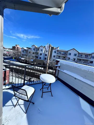 a view of a balcony with wooden benches